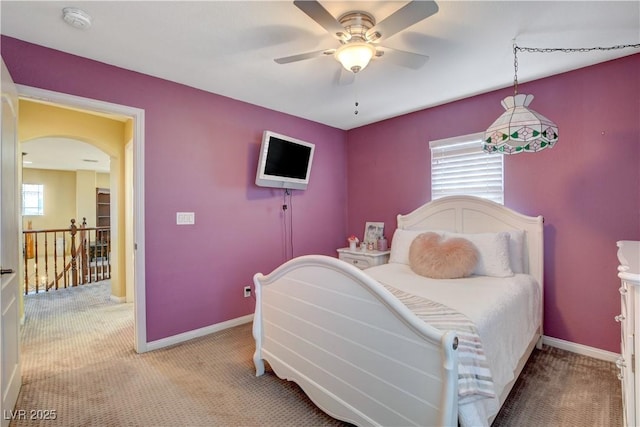 bedroom featuring carpet, multiple windows, and baseboards