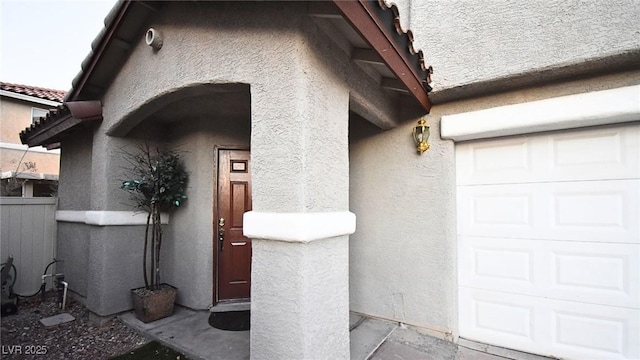 doorway to property featuring stucco siding