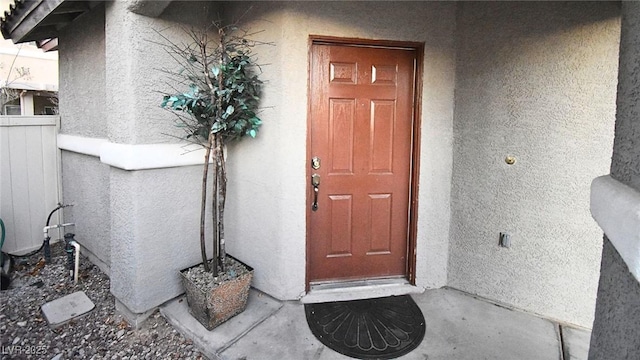 view of exterior entry with stucco siding