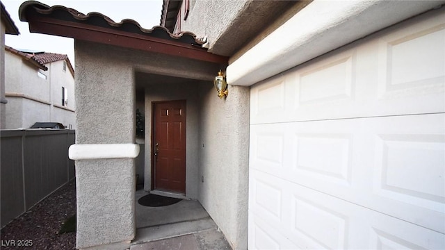 view of exterior entry featuring stucco siding