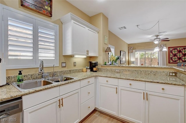 kitchen featuring visible vents, a ceiling fan, a sink, white cabinetry, and stainless steel dishwasher