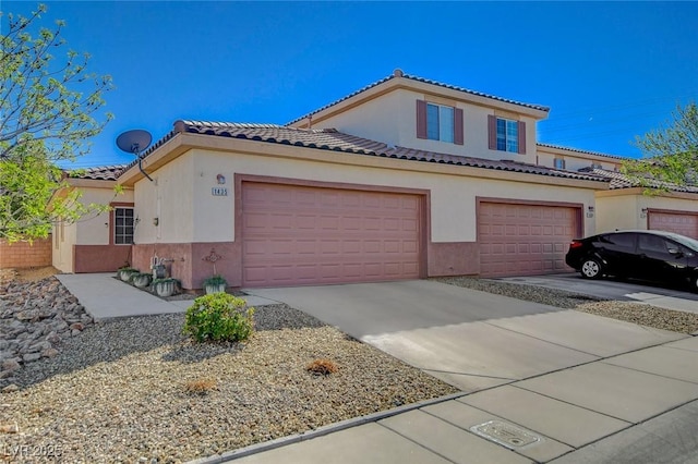 view of front of home featuring driveway, a tiled roof, and stucco siding