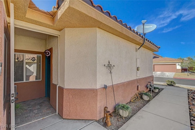 view of property exterior featuring a tile roof and stucco siding