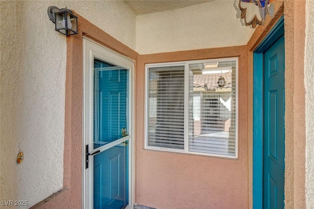 entrance to property with stucco siding