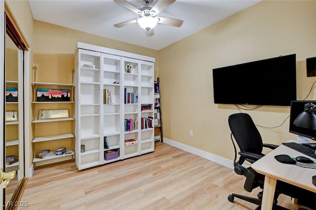 office area with wood finished floors, a ceiling fan, and baseboards