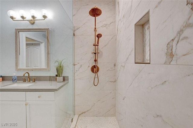 full bath with a marble finish shower and vanity