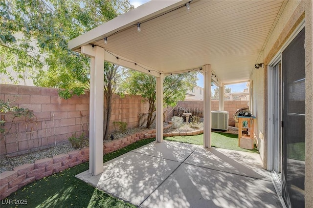 view of patio featuring central AC unit and a fenced backyard