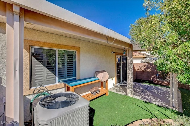 view of patio featuring central AC and fence