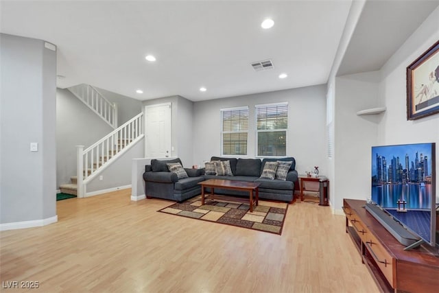 living room featuring light wood-style floors, stairs, visible vents, and recessed lighting