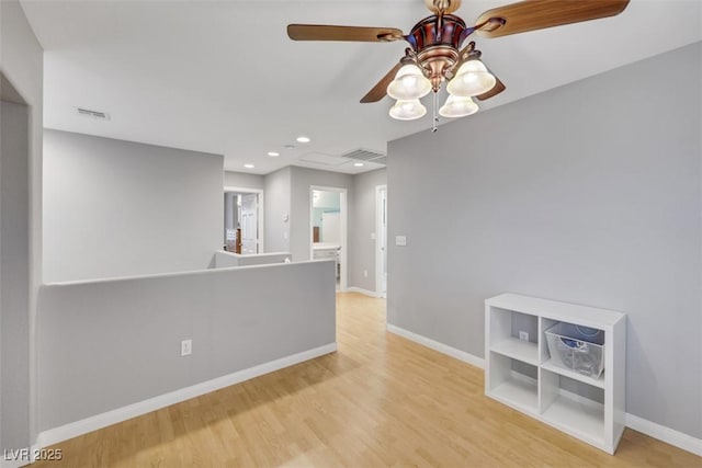 unfurnished room with recessed lighting, baseboards, visible vents, and light wood finished floors