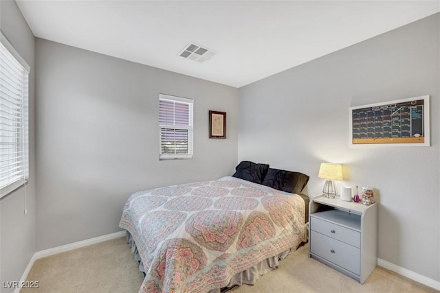 bedroom with light carpet, baseboards, and visible vents