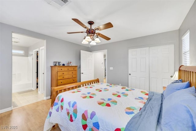 bedroom featuring visible vents, baseboards, a ceiling fan, a closet, and light wood-type flooring