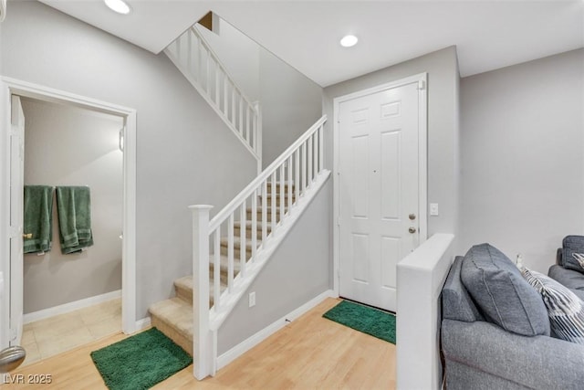 entrance foyer featuring recessed lighting, stairway, baseboards, and wood finished floors