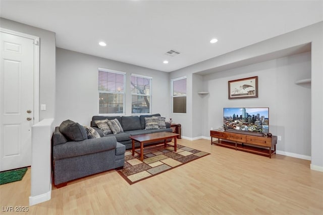 living room featuring recessed lighting, visible vents, light wood-style flooring, and baseboards