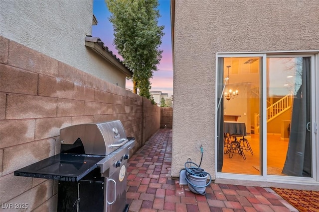 view of patio featuring area for grilling and fence