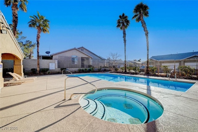 community pool featuring a community hot tub, a patio area, and fence