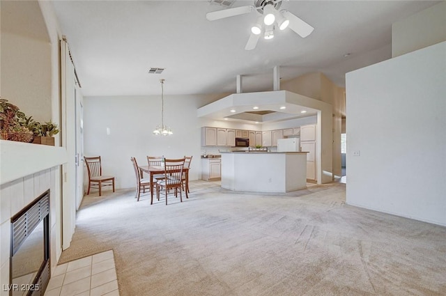 unfurnished living room with light carpet, visible vents, ceiling fan with notable chandelier, vaulted ceiling, and recessed lighting