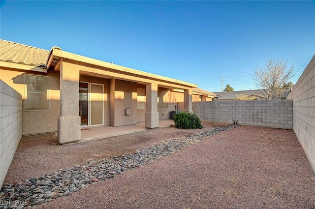 exterior space with a patio, a fenced backyard, and stucco siding