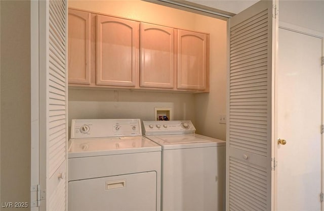 clothes washing area featuring cabinet space and separate washer and dryer