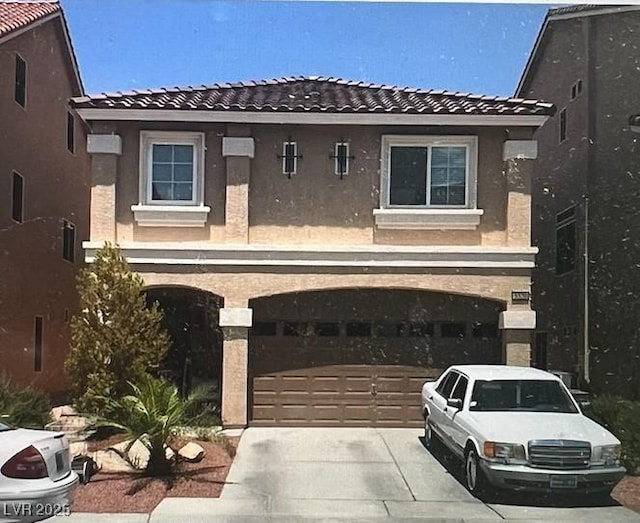 5320 Tartan Hill Ave, Las Vegas, NV 89141 - view of front of house with concrete driveway, a tile roof, and stucco siding