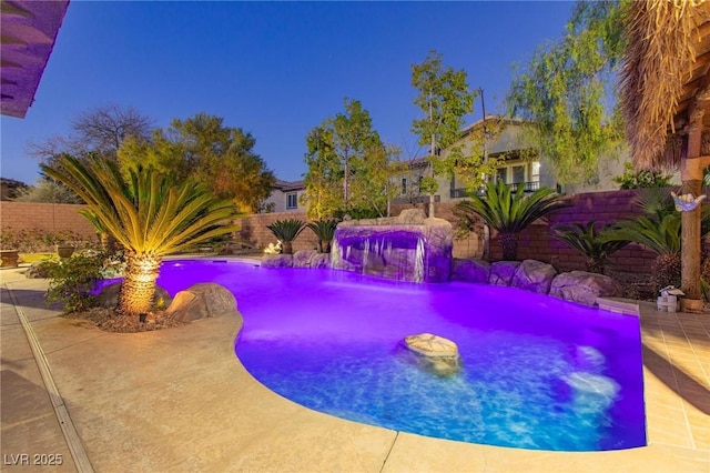 outdoor pool with a patio and a fenced backyard