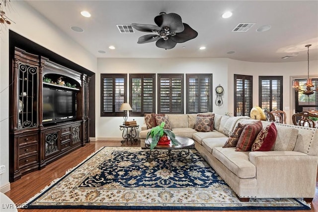 living room with wood finished floors, visible vents, and recessed lighting