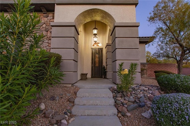 property entrance with stucco siding