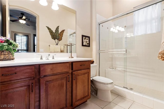 full bathroom featuring ceiling fan, a stall shower, toilet, and tile patterned floors