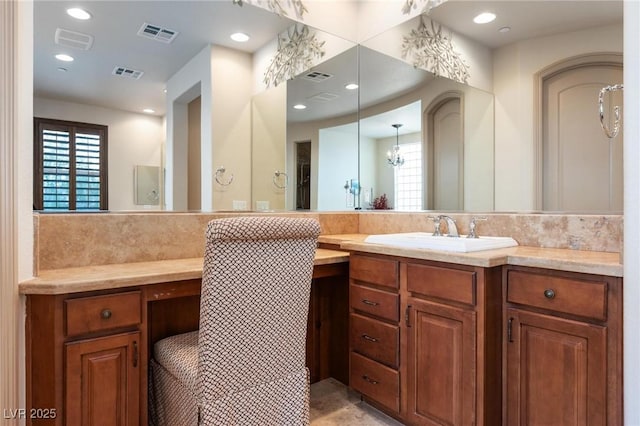 bathroom featuring a healthy amount of sunlight, visible vents, and vanity