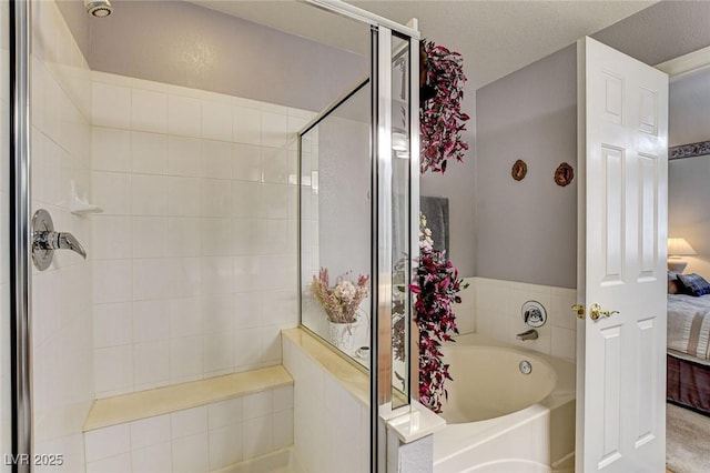 ensuite bathroom with a bath, a shower stall, a textured ceiling, and connected bathroom