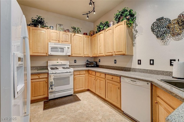 kitchen with light countertops, white appliances, and light brown cabinets