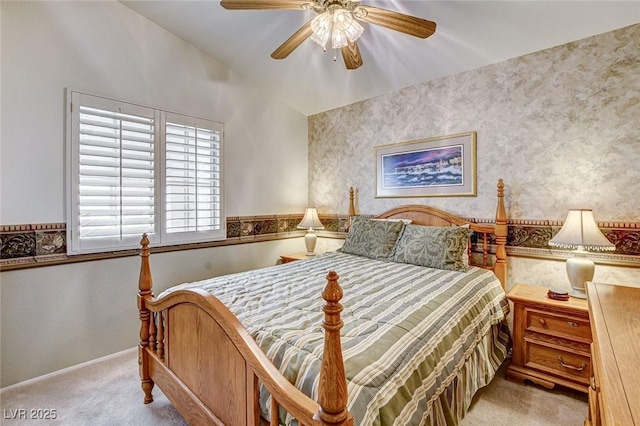 bedroom featuring ceiling fan, wallpapered walls, baseboards, and light colored carpet