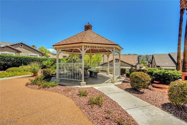 surrounding community featuring a gazebo, fence, and a gate