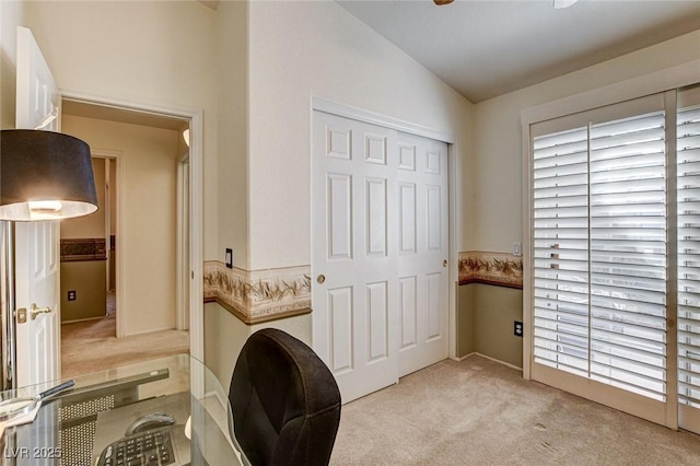 laundry area featuring light carpet