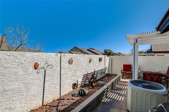 view of patio / terrace with a fenced backyard, central AC, and a pergola