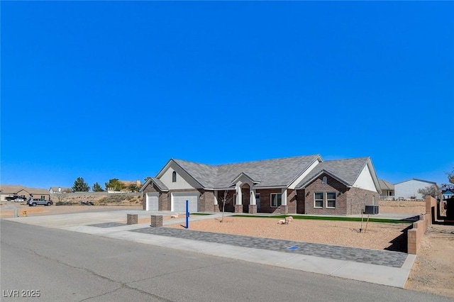 view of front of property with driveway, an attached garage, and brick siding