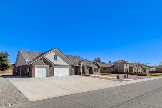 single story home featuring a garage, brick siding, concrete driveway, a residential view, and stucco siding