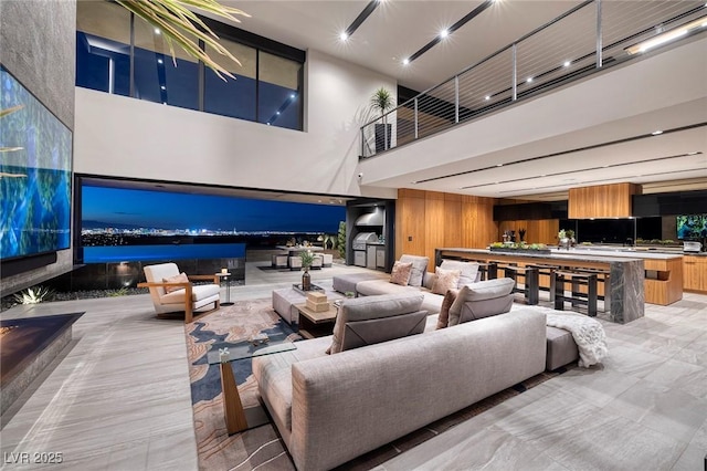 living room featuring wood walls and a high ceiling