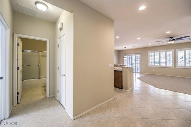 hallway featuring recessed lighting, visible vents, baseboards, and light tile patterned floors