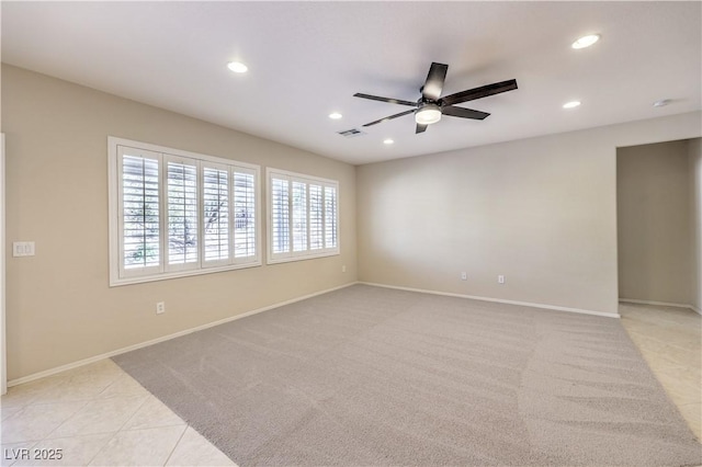 empty room featuring light carpet, baseboards, a ceiling fan, and recessed lighting