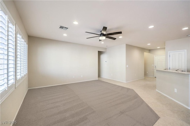 spare room featuring recessed lighting, light carpet, a ceiling fan, baseboards, and visible vents