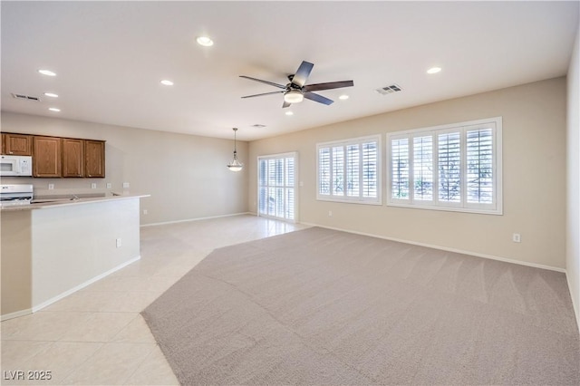 unfurnished living room featuring a ceiling fan, recessed lighting, visible vents, and light tile patterned flooring