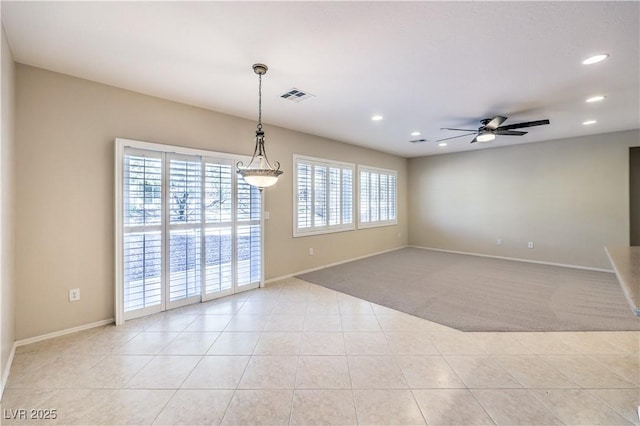 empty room featuring light tile patterned floors, recessed lighting, visible vents, light carpet, and baseboards