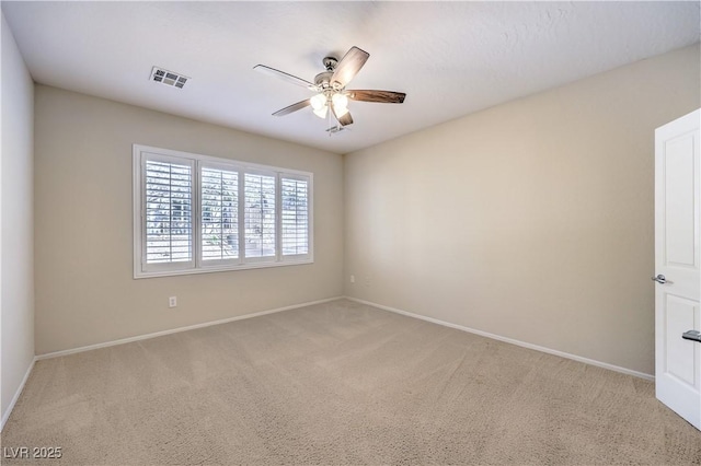 unfurnished room featuring ceiling fan, baseboards, visible vents, and light colored carpet