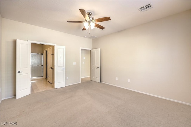 unfurnished bedroom featuring light carpet, baseboards, visible vents, connected bathroom, and ceiling fan