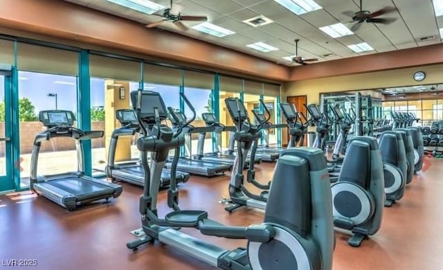 exercise room with a paneled ceiling and a ceiling fan