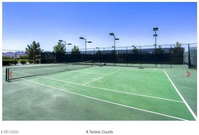 view of sport court featuring fence