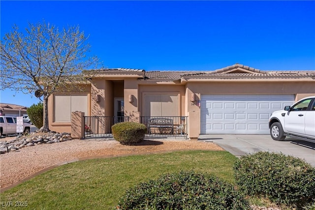 single story home with a garage, concrete driveway, a tile roof, and stucco siding