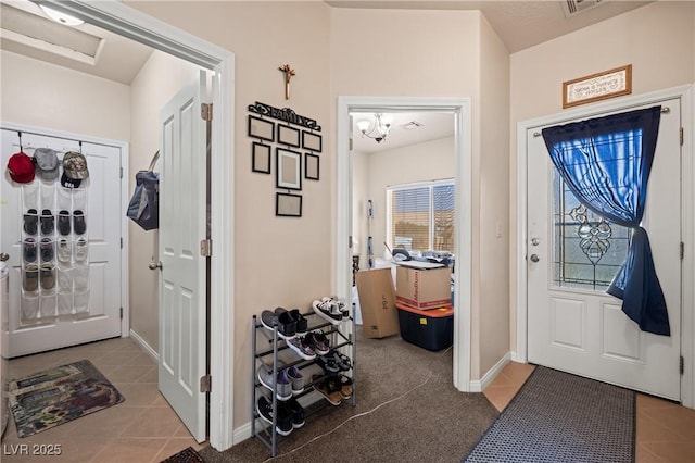 foyer with tile patterned flooring and baseboards