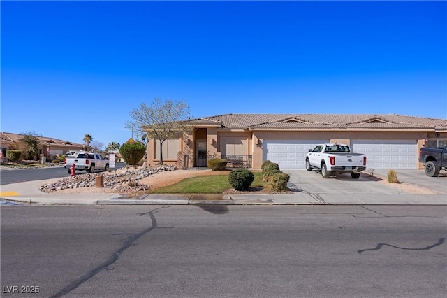 single story home with driveway, an attached garage, a tiled roof, and stucco siding